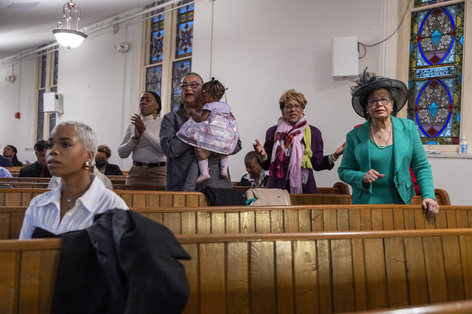 Parishioners sing and pray during Palm Sunday services at the Metropolitan AME Church in Washington, Sunday, March 24, 2024. Rev. William Lamar IV at Washington, D.C.’s historic Metropolitan AME has adjusted to offering both virtual and in-person services since the COVID-19 pandemic. After a noticeable attendance drop, more Metropolitan congregants are choosing in-person worship over virtual, even as they mourn members who died from COVID-19.(AP Photo/Amanda Andrade-Rhoades)