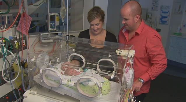 Parents Pip and Brian overwhelmed at the arrival of their triplet girls. Here they look proudly on at a sleeping Isobel. Photo: 7News