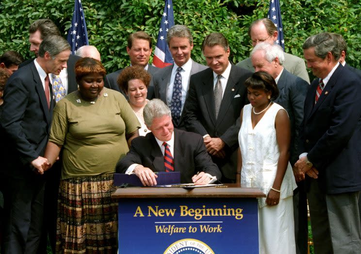 President Bill Cllinton signs a welfare reform bill that ends the 61-year-old federal guarantee of aid to the poor, August 22, 1996.