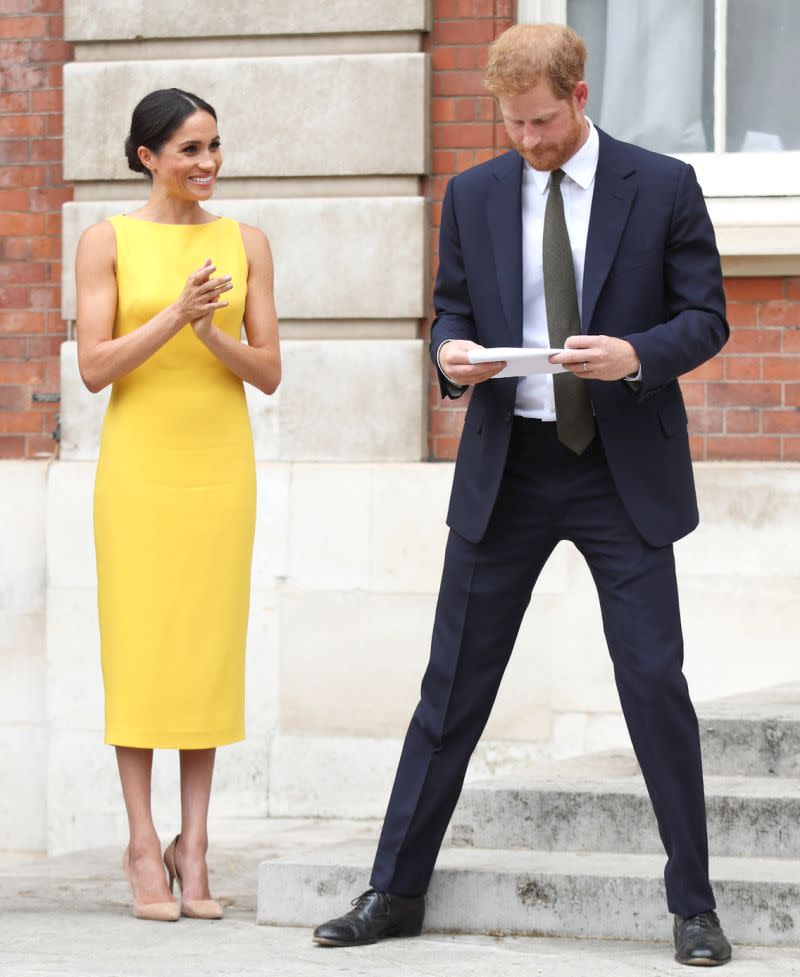 Meghan went sans clutch bag and kept her hands free to applaud her new husband [Photo: Getty]