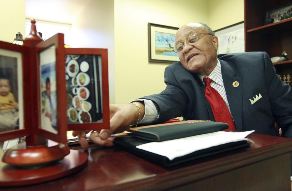 Del. Rudy Cane, D-37A-Wicomico, flips through pictures on his desk between meetings during the opening of the Maryland General Assembly on Jan. 9, 2008, in Annapolis.