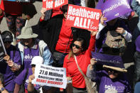 People march in a "Save Obamacare" rally on the seventh anniversary of Obamacare's signing, in Los Angeles, California, U.S. March 23, 2017. REUTERS/Lucy Nicholson