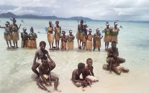 Students attend a climate change protest in Marovo Island, Solomon Islands - Credit: Reuters