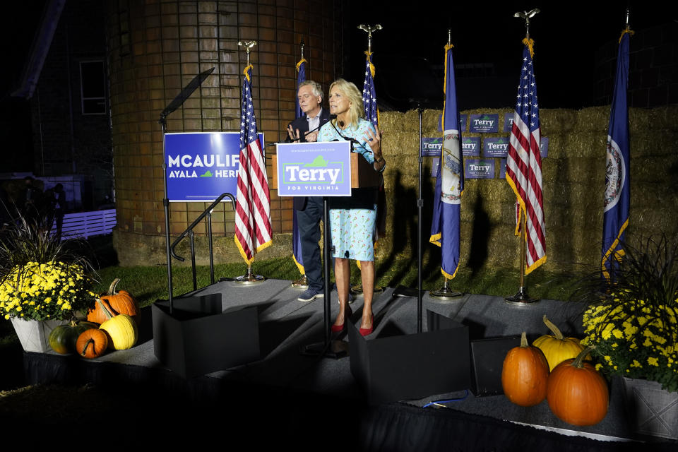 First lady Jill Biden, front, gestures as Democratic gubernatorial candidate Terry McAuliffe listens during a rally in Richmond, Va., Friday, Oct. 15, 2021. McAuliffe will face Republican Glenn Youngkin in the November election. (AP Photo/Steve Helber)