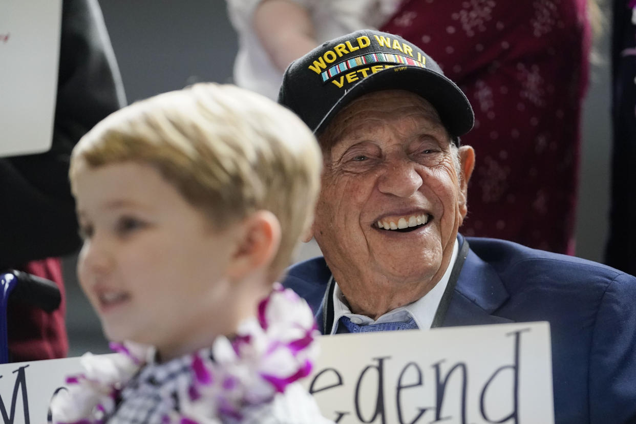 World War II veteran Joseph Eskenazi, who at 104 years and 11 months old is the oldest living veteran to survive the attack on Pearl Harbor, sits with his great grandson Mathias, 4, at an event celebrating his upcoming 105th birthday at the National World War II Museum in New Orleans, Wednesday, Jan. 11, 2023. (AP Photo/Gerald Herbert)