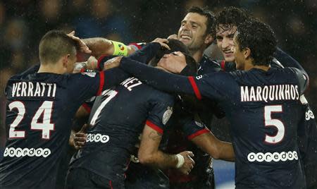 Paris St Germain's players celebrate after Edinson Cavani scored a goal against FC Lorient during their French Ligue 1 soccer match at the Parc des Princes Stadium in Paris November 1, 2013. REUTERS/Benoit Tessier