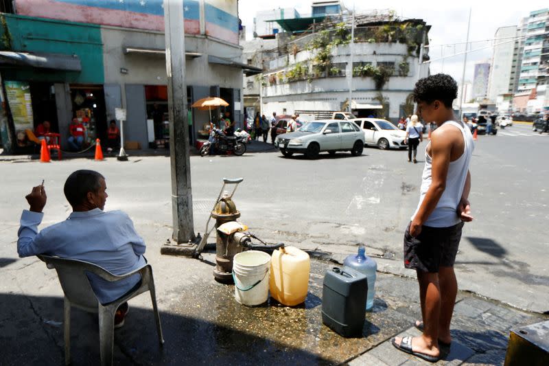 People get water from a fire hydrant, in Caracas