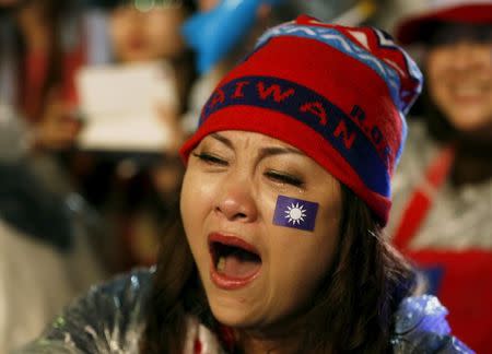 A woman shows her support for the ruling Nationalist Kuomintang Party (KMT) chairman Eric Chu during a campaign rally a day before the election in New Taipei City, Taiwan January 15, 2016. REUTERS/Olivia Harris