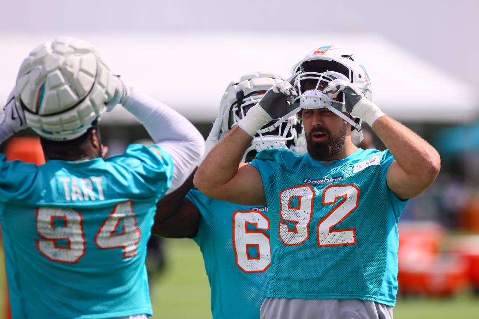 Dolphins defensive tackle Zach Sieler (92) puts on his helmet before practicing last week at Baptist Health Training Complex.