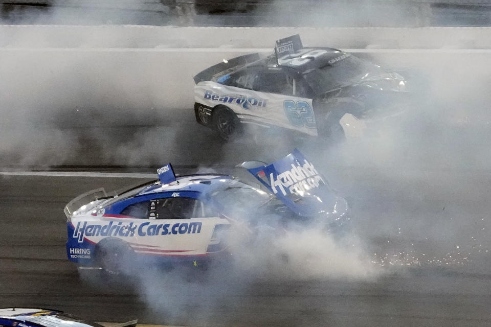 Kyle Larson (5) and Noah Gragson (62) crash during the NASCAR Daytona 500 auto race Sunday, Feb. 20, 2022, at Daytona International Speedway in Daytona Beach, Fla. (AP Photo/Chris O'Meara)