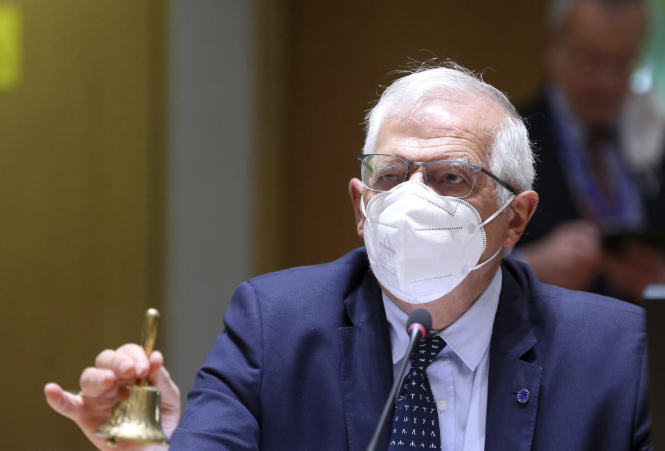 European Union foreign policy chief Josep Borrell rings a bell to signify the start of a meeting of EU foreign ministers to discuss the situation in Ukraine, at the European Council building in Brussels, Monday, April 19, 2021. European Union foreign ministers on Monday assessed the bloc's strategy towards Russia in the wake of the military buildup on Ukraine's borders and amid the weakening health of imprisoned opposition leader Alexei Navalny. (Francois Walschaerts, Pool via AP)