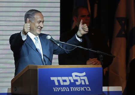 Israeli Prime Minister Benjamin Netanyahu gestures to supporters at party headquarters in Tel Aviv March 18, 2015. REUTERS/Nir Elias