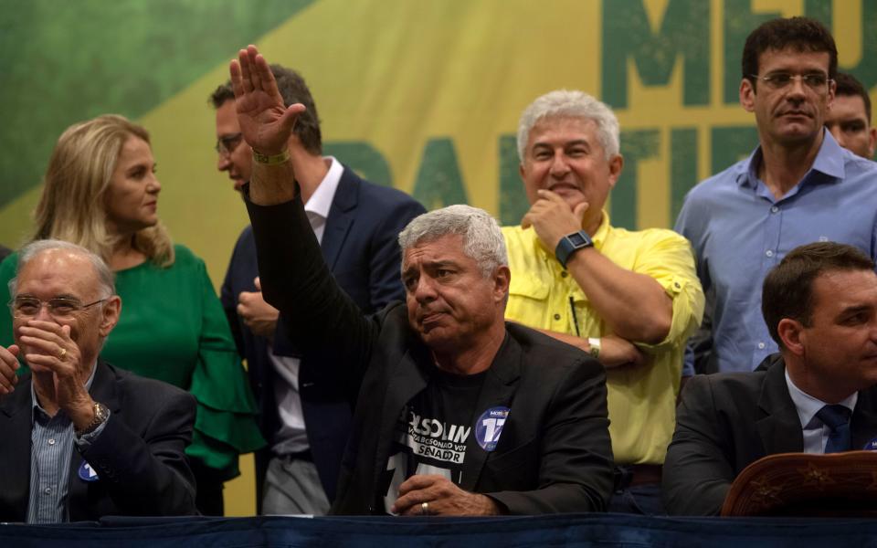 Brazilian Social Liberal Party (PSL) Senator-elect for Sao Paulo Major Olimpio gestures as he asks supporters to stop booing journalists during PSL presidential candidate Jair Bolsonaro's press conference in Rio de Janeiro, Brazil on October 11, 2018. - The far-right frontrunner to be Brazil's next president, Jair Bolsonaro, stumbled Wednesday by spooking previously supportive investors, while a spate of violent incidents pointed to deep polarization caused by the election race. (Photo by Mauro Pimentel / AFP)        (Photo credit should read MAURO PIMENTEL/AFP/Getty Images)