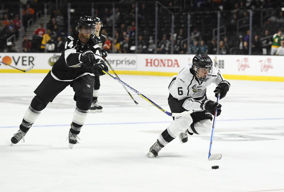 Singer Justin Bieber, right, of Team Gretzky, skates with the puck as Chris Pronger of Team Lemieux reaches in during the first period of the NHL All-Star Celebrity Shootout at Staples Center, Saturday, Jan. 28, 2017, in Los Angeles. The NHL All-Star Game is scheduled to be played at Staples Center on Sunday. (AP Photo/Mark J. Terrill)