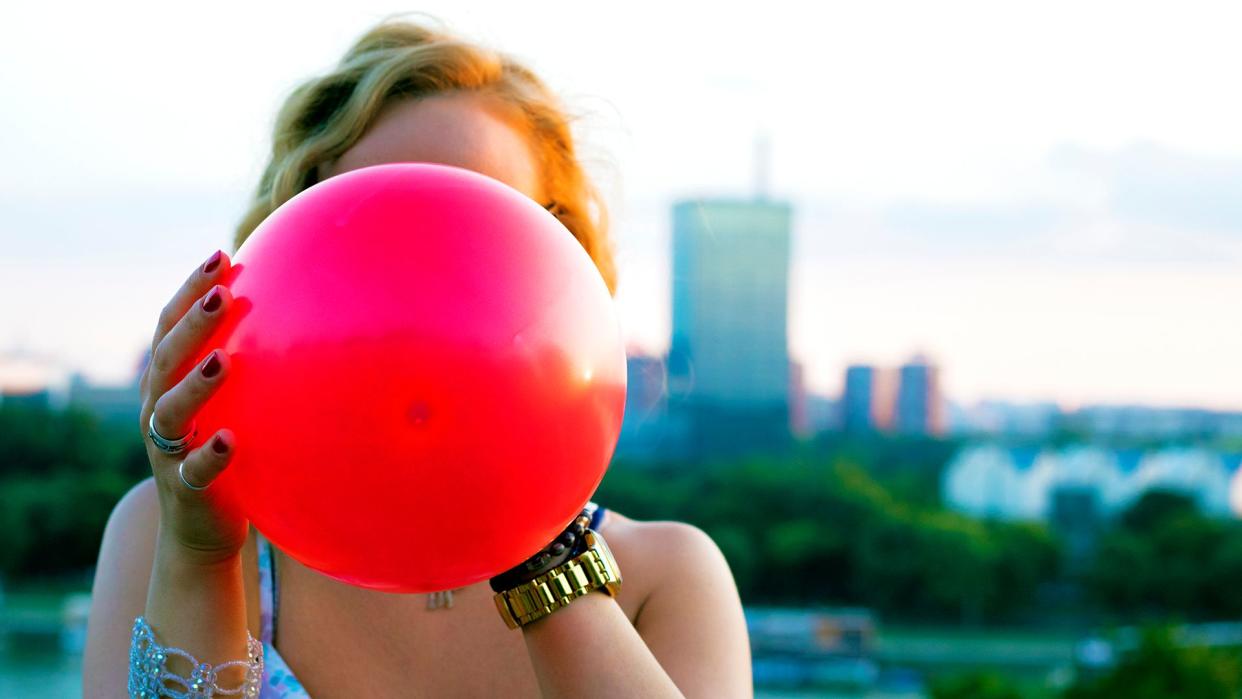 woman inflating balloon.