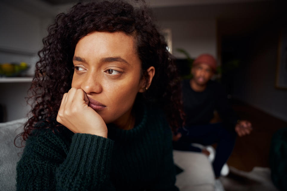 a woman looking away with her back towards her partner