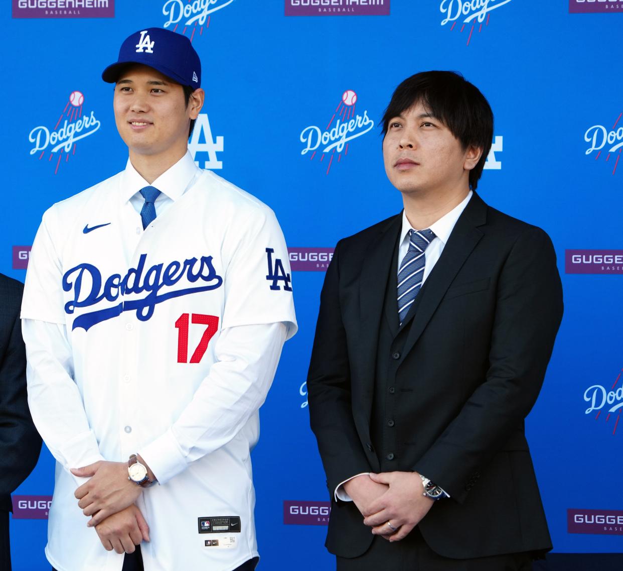 Shohei Ohtani stands with interpreter Ippei Mizuhara at an introductory press conference at Dodger Stadium.