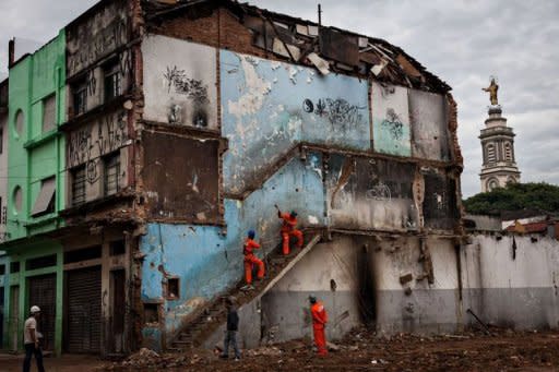 Workers demolish an abandoned building where drug addicts used to live, as part of the city's cleanup project of the area known as 'Cracolandia' (Crackland, in English), in downtown Sao Paulo, Brazil. A muscular police operation to evict drug users from central Sao Paulo is triggering howls of protest from rights groups who say the crackdown's aim is to sanitize the area for developers