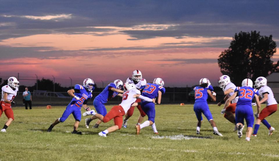 Friday night lights under a beautiful September sky in south central Indiana. Owen Valley's Cale Nickless tackles Indian Creek's Brandon Murray.