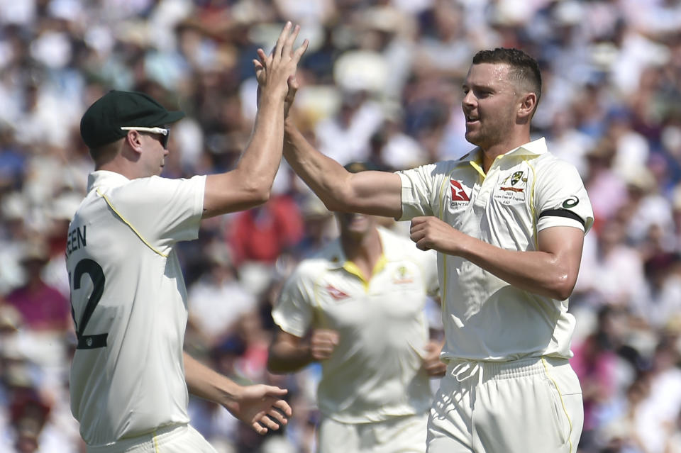 Australia's Josh Hazlewood, right, celebrates with Australia's Cameron Green after taking the wicket of England's Ben Duckett on day one of the first Ashes Test cricket match between England and Australia at Edgbaston, Birmingham, England, Friday, June 16, 2023. (AP Photo/Rui Vieira)