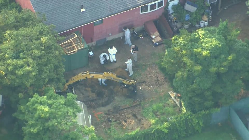 Investigators search the backyard of Rex Heuermann's home on Sunday.  - News 12 Long Island