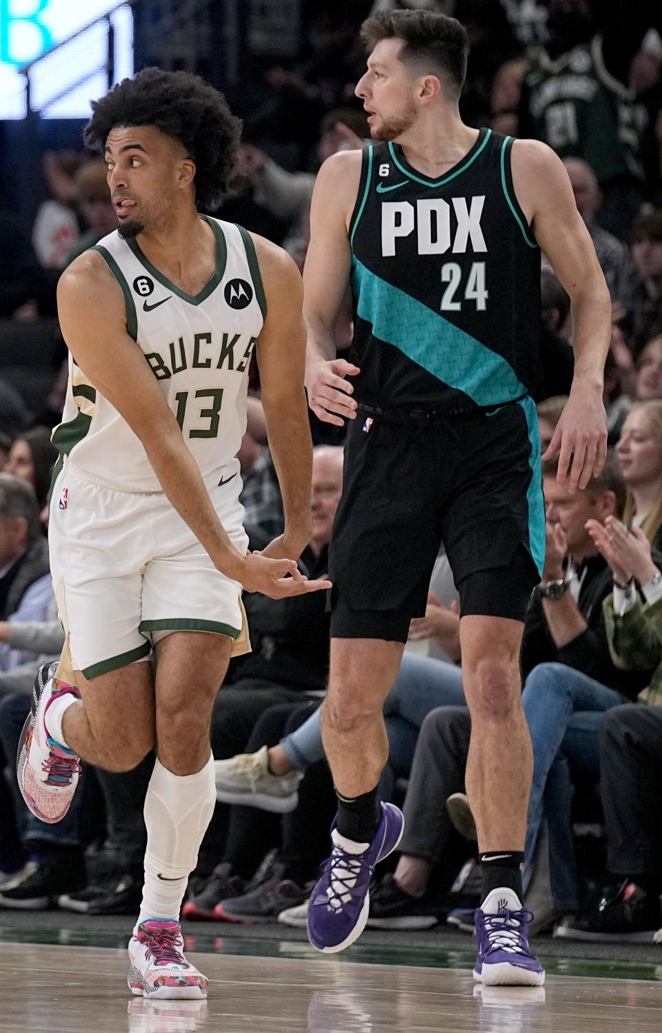 Milwaukee Bucks forward Jordan Nwora (13) runs past Portland Trail Blazers forward Drew Eubanks (24) after hitting a three-point basket during the first half of their game Wednesday, April 27, 2022 at Firserv Forum in Milwaukee, Wis.