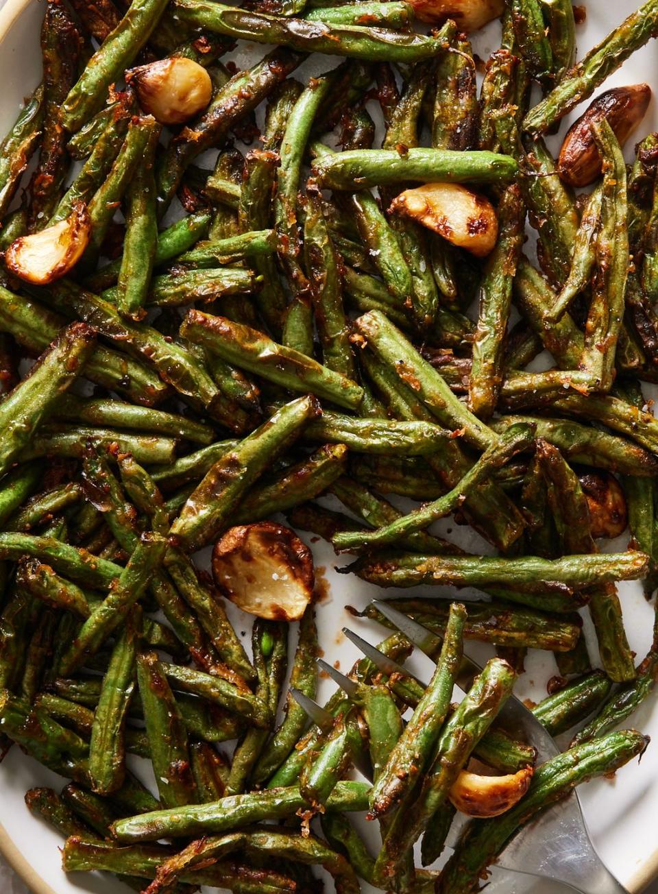 <p>These green beans come with a treat: 8 cloves of creamy, buttery garlic that get air-fried alongside the green beans for bites of <a href="https://www.delish.com/cooking/recipe-ideas/a22553960/how-to-roast-garlic/" rel="nofollow noopener" target="_blank" data-ylk="slk:roasted garlic;elm:context_link;itc:0;sec:content-canvas" class="link ">roasted garlic</a> that don’t involve turning on your oven. You can eat them alongside the beans or reserve them for another use, like smearing alongside butter and flaky sea salt on a slice of toasted <a href="https://www.delish.com/cooking/recipe-ideas/a25810151/how-to-make-sourdough-bread-recipe/" rel="nofollow noopener" target="_blank" data-ylk="slk:sourdough bread;elm:context_link;itc:0;sec:content-canvas" class="link ">sourdough bread</a>. 😋</p><p>Get the <strong><a href="https://www.delish.com/cooking/recipe-ideas/a41234938/air-fryer-green-beans-recipe/" rel="nofollow noopener" target="_blank" data-ylk="slk:Air Fryer Green Beans recipe;elm:context_link;itc:0;sec:content-canvas" class="link ">Air Fryer Green Beans recipe</a></strong>.</p>