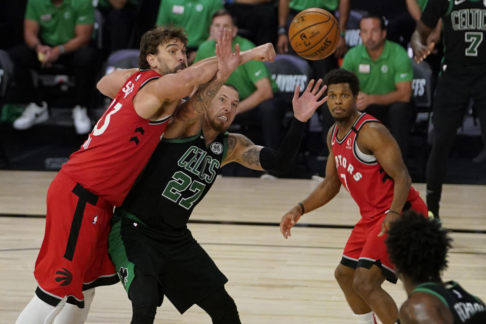 Boston Celtics' Daniel Theis (27) and Toronto Raptors' Marc Gasol (33) battle for a rebound during the second half of an NBA conference semifinal playoff basketball game Monday, Sept. 7, 2020, in Lake Buena Vista, Fla. (AP Photo/Mark J. Terrill)