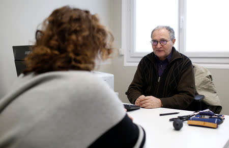 Retired French doctor Jean-Francois Rechner, 67, listens to a patient during a consultation at the 'Service Medical de Proximite' clinic in Laval, France, November 8, 2018. Picture taken November 8, 2018. REUTERS/Stephane Mahe