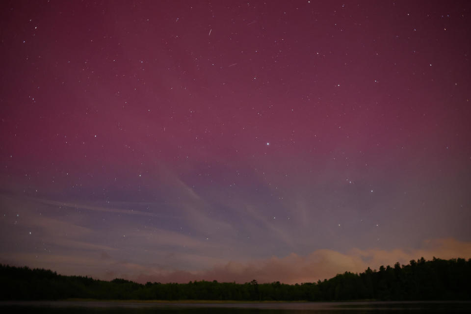 Northern lights are seen over the lake near Szczytno, Poland, on May 10, 2024. / Credit: Kacper Pempel / REUTERS