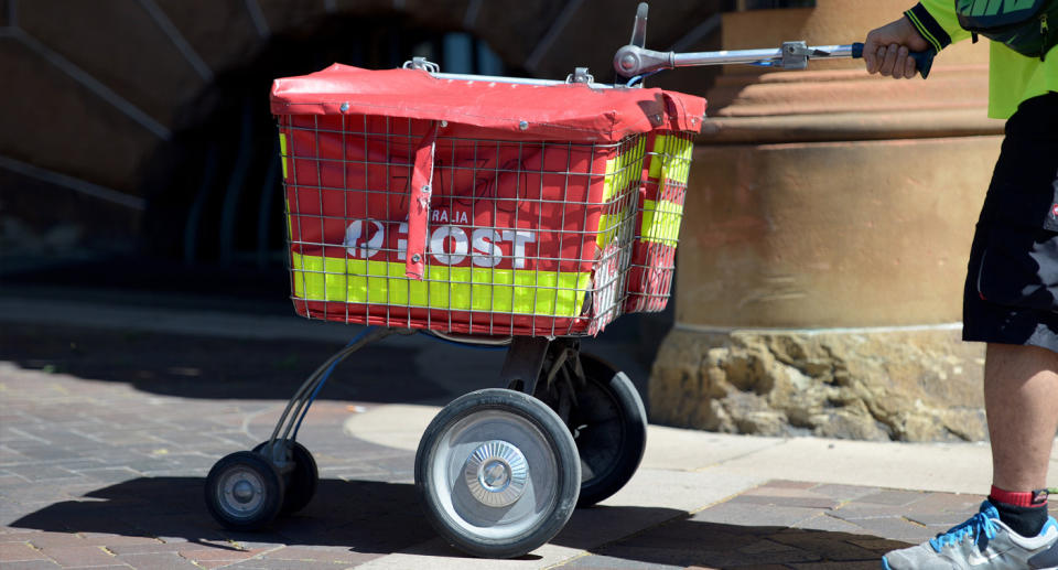 Australia Post mail being delivered by worker.