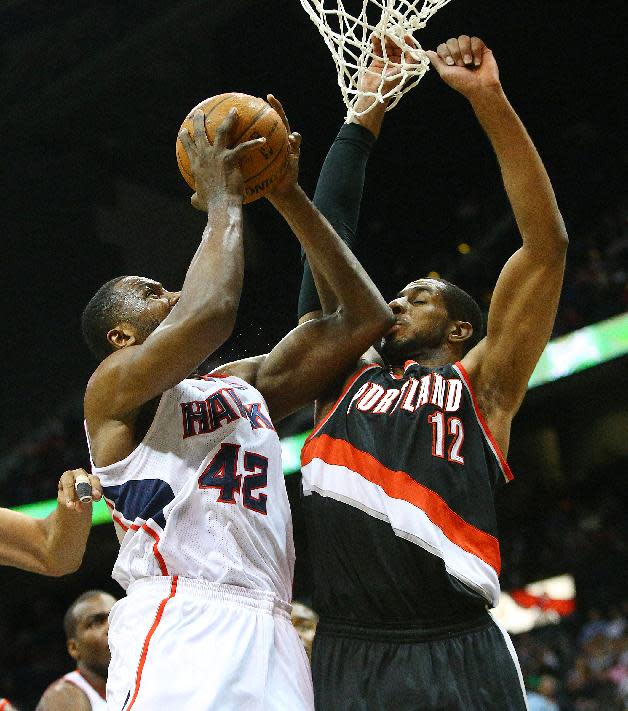 Back on the floor after being out several games Trail Blazers forward LaMarcus Aldridge takes an elbow while defending against a drive to the basket by Hawks forward Elton Brand during the first half of an NBA basketball game on Thursday, March 27, 2014, in Atlanta. (AP Photo/Atlanta Journal-Constitution, Curtis Compton) MARIETTA DAILY OUT; GWINNETT DAILY POST OUT; LOCAL TV OUT; WXIA-TV OUT; WGCL-TV OUT