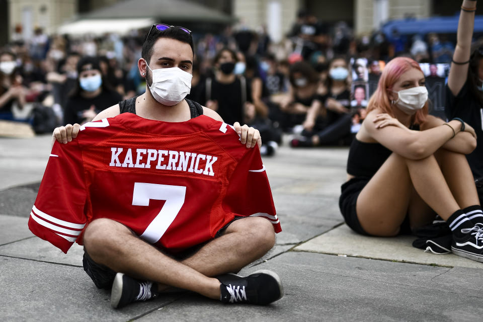 PIAZZA CASTELLO, TURIN, ITALY - 2020/06/06: A protester holds a shirt of Colin Kaepernick during a demonstration calling for justice for George Floyd, who died May 25 after being restrained by police in Minneapolis, USA. People have protested peacefully in Turin to show solidarity with anti-racism movement Black Lives Matter. (Photo by Nicolò Campo/LightRocket via Getty Images)