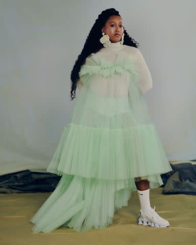 <p>Joshua Kissi</p> Adeam top and skirt, Fendi turtleneck, Karo Karu earrings, and Nike socks and shoes.