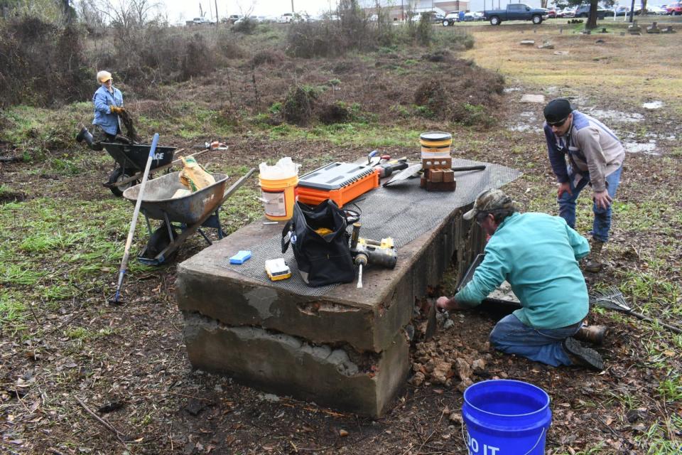 Jaune Gagnard (left) said God led her to the cemeteries on Hunter Street in Pineville to clean them up. She is assisted by Kelby Hernandez (far right) from her prayer group. Tom Bradfield is a retired brick and concrete mason who helped repair one of the broken tombs. “All these graves, all these souls, they were somebody one time,” said Gagnard. “And they still matter. So we just do our part."