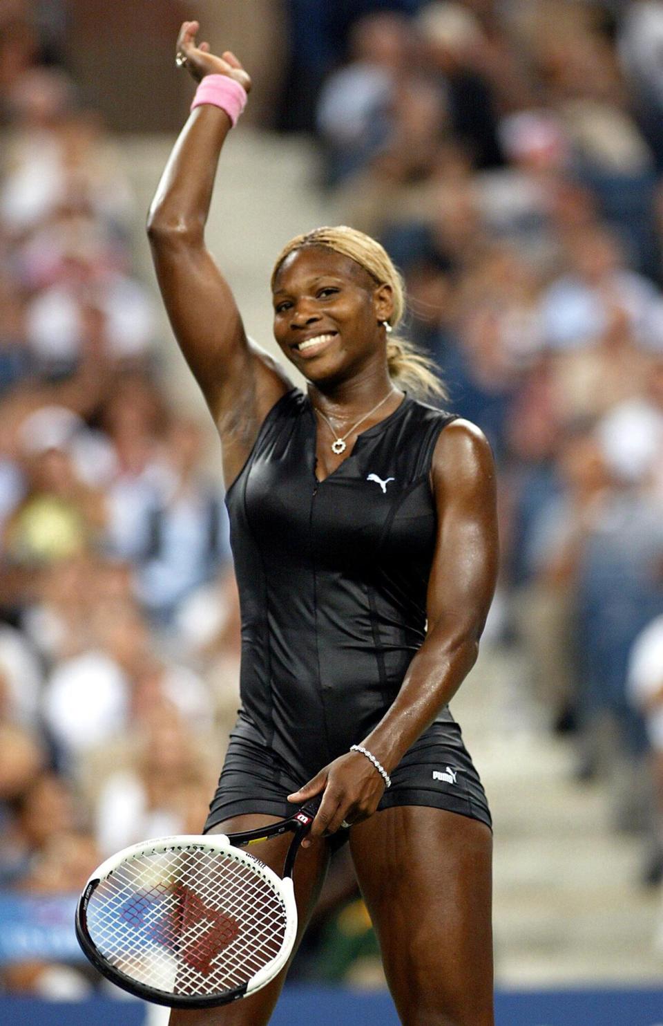 Serena Williams of the US waves to the crowd after defeating Corina Morariu of the US during first round action at the US Open Tennis tournament 26 August, 2002 at Flushing Meadows, NY. Williams won 6-3, 6-3.