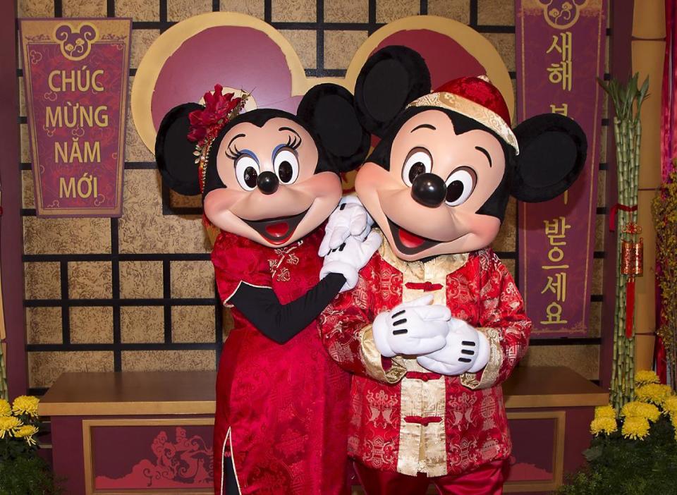 This January 2016 image provided by Disneyland Resort shows Mickey Mouse and Minnie Mouse dressed in red for a Lunar New Year celebration at Disney California Adventure Park in Anaheim, Calif. The park will celebrate year of the rooster this year from Jan. 20 through Feb. 5 with live performances, activities, decor, special food and Disney characters dressed for the Lunar New Year holiday. (Disneyland Resort via AP)