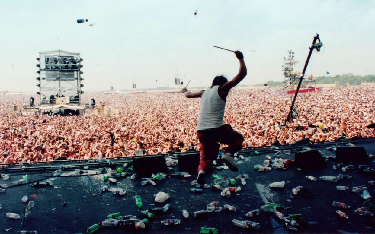 Kid Rock performing onstage at Woodstock '99 - Netflix