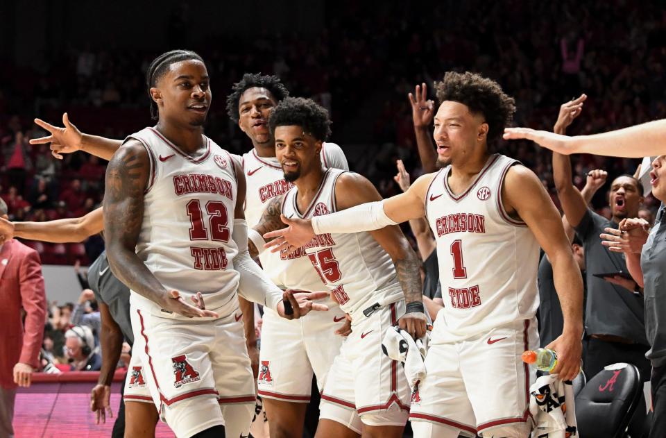 Feb 17, 2024; Tuscaloosa, Alabama, USA; Alabama guard Latrell Wrightsell Jr. (12) celebrates with the 
Alabama bench after making a three pointer late in the game with Texas A&M at Coleman Coliseum. Alabama defeated Texas A&M 100-75. Mandatory Credit: Gary Cosby Jr.-USA TODAY Sports