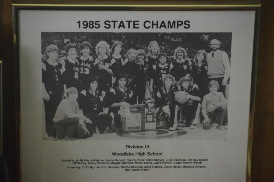 A team photo of Woodlake High School's 1985 state championship girls basketball team hangs on the wall in Central Section historian Bob Barnett's home in Fresno.