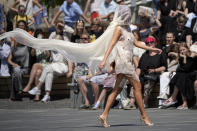 A model displays a collection by graduates of the British Higher School of Art & Design during the Fashion Week at Zaryadye Park near Red Square in Moscow, Russia, Friday, June 24, 2022. (AP Photo/Alexander Zemlianichenko)