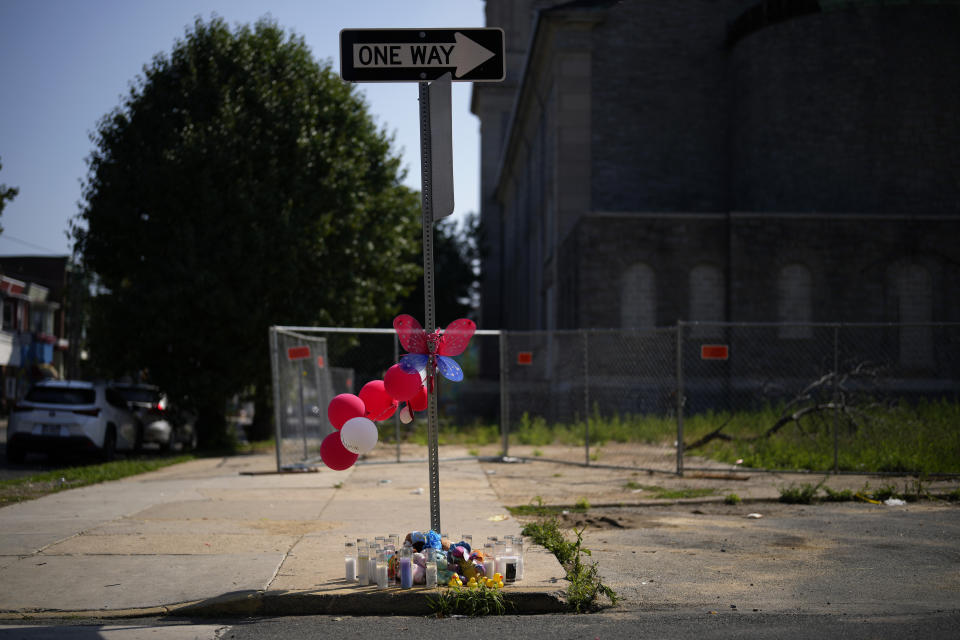 Mementos and candles are seen at a memorial for Dymir Stanton, 29, a victim of a fatal shooting spree, Thursday, July 6, 2023, in Philadelphia. (AP Photo/Matt Slocum)