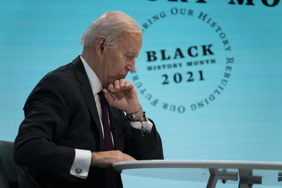 President Joe Biden looks at his notes during a virtual roundtable with Black essential workers hosted by Domestic Policy Council director Susan Rice, in the South Court Auditorium on the White House campus, Tuesday, Feb. 23, 2021, in Washington. (AP Photo/Evan Vucci)