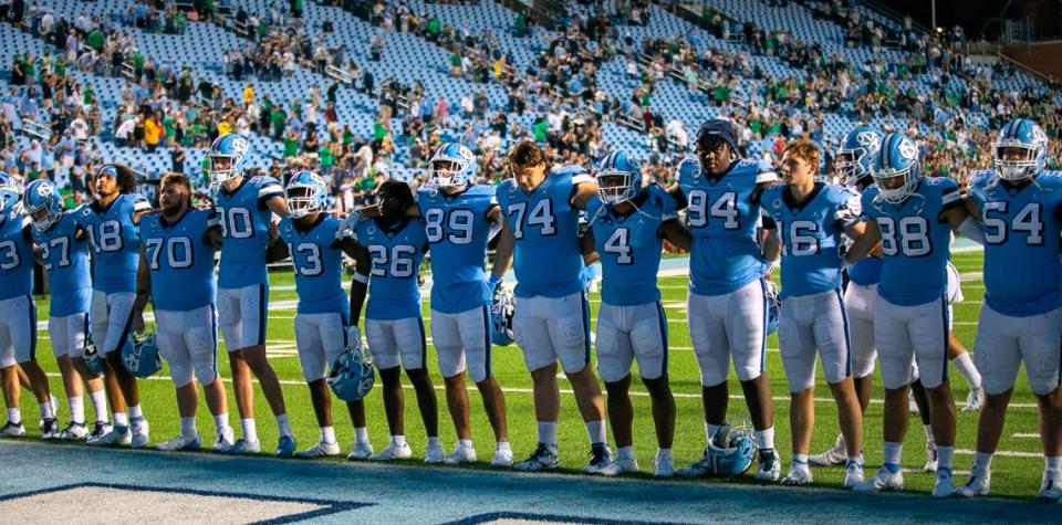 With the stadium nearly empty, the North Carolina football team stands together for the Alma Mater following their 45-32 loss to Notre Dame on Saturday, September 24, 2022 at Kenan Stadium in Chapel Hill, N.C. Robert Willett/rwillett@newsobserver.com