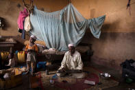 <p>A man writes verses of the Quran on a wooden board at a displaced shelter in Bangui, Central African Republic, April 24, 2017. (Baz Ratner/Reuters) </p>