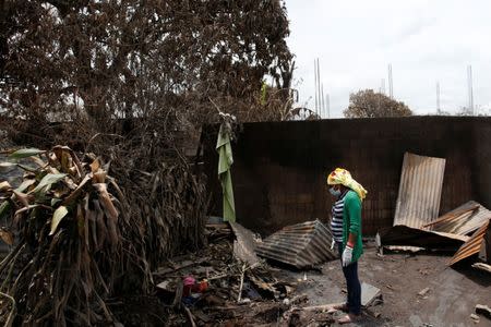 Eufemia Garcia, 48, who lost 50 members of her family during the eruption of the Fuego volcano, searches for her family in San Miguel Los Lotes in Escuintla, Guatemala, June 13, 2018. REUTERS/Carlos Jasso