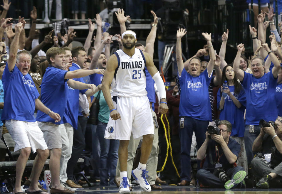 Fans cheer as Dallas Mavericks guard Vince Carter stands in the corner after he made the game-winning 3-point basket at the buzzer in the fourth quarter against the San Antonia Spurs in Game 3 in the first round of the NBA basketball playoffs in Dallas, Saturday, April 26, 2014. The Mavericks won 109-108. (AP Photo/LM Otero)