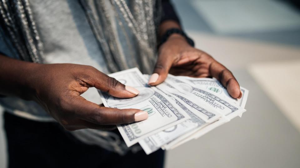 Hands holding a dollar bills