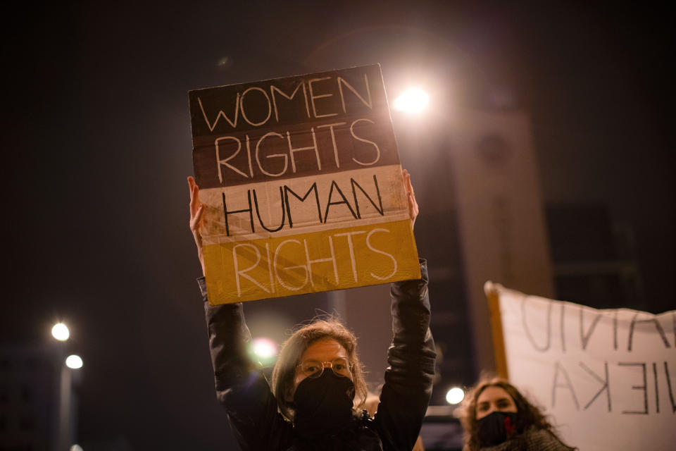 A demonstrator holds a banner during a protest against a top court ruling restricting abortions in Warsaw, Poland, Wednesday, Nov. 18, 2020. Poland already had one of Europe's most restrictive abortion laws, and the ruling would mean that the only legal reasons for abortion would be rape, incest or if the woman's life is in danger. (AP Photo/Agata Grzybowska)