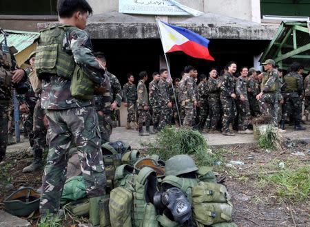 The Philippine flag is held by a soldier after government troops cleared the area from pro-Islamic State militant groups inside a war-torn area in Bangolo town, Marawi City, southern Philippines October 23, 2017. REUTERS/Romeo Ranoco